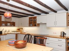 A kitchen with a table and chairs at Hope Cottage in Riddlecombe, near Winkleigh