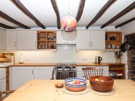 A kitchen with tables and chairs at Hope Cottage in Riddlecombe, near Winkleigh
