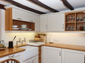 A kitchen with a sink and cabinets at Hope Cottage, Riddlecombe, near Winkleigh
