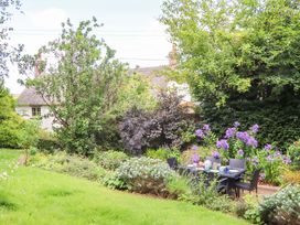 A garden with a seating area and flowers at Hope Cottage, Riddlecombe near Winkleigh