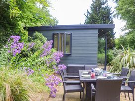 An outdoor dining area with a table and chairs at Hope Cottage in Riddlecombe, near Winkleigh