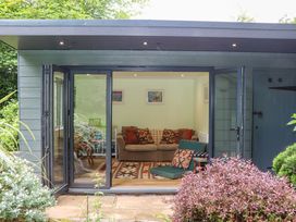 A garden room with a sofa and a table at Hope Cottage in Riddlecombe, near Winkleigh