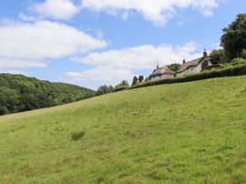 Houses on a hillside in a field at Hope Cottage near Riddlecombe, near Winkleigh