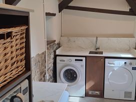 A laundry room with a washing machine and dryer at Hope Cottage in Riddlecombe, near Winkleigh