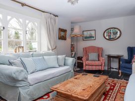 A living room with a sofa and coffee table at Chapel Cottage in Welcombe