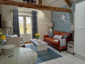 A living room with a sofa and coffee table at Saltwind Granary in Clovelly