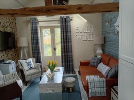 A living room with a sofa and armchairs at Saltwind Granary in Clovelly