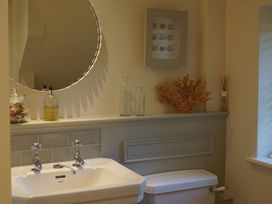 A bathroom with a sink and toilet at Coach House Cottage in Strete, near Dartmouth