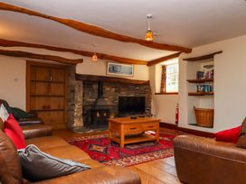 A living room with a fireplace and furniture at East Bickleigh in Halwell