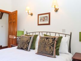 A bedroom with a bed and decorative pillows at East Bickleigh in Halwell