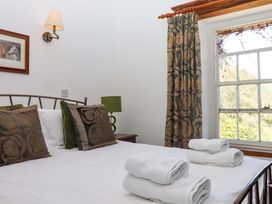 A bedroom with a bed and window at East Bickleigh in Halwell