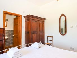 A bedroom with a bed and wardrobe at East Bickleigh in Halwell