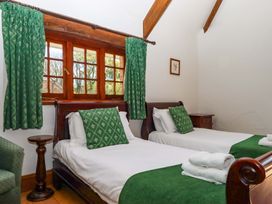 A bedroom with two beds and curtains at East Bickleigh Halwell