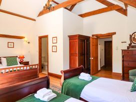 A bedroom with two beds and a wardrobe at East Bickleigh in Halwell