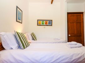 A bedroom with two beds and artwork on the wall at East Bickleigh in Halwell