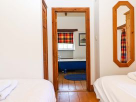 A bedroom with a door leading to a bathroom at East Bickleigh Halwell