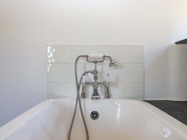 A bathtub with faucet and showerhead at East Bickleigh Halwell