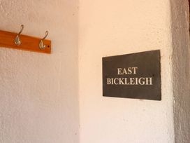 A wall with hooks and nameplate at East Bickleigh in Halwell
