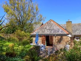 A garden view with a building and furniture at East Bickleigh Halwell