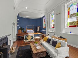 A living room with a sofa coffee table and piano at The Music Room Aveton Gifford