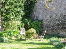 A garden with a table and two chairs at The Music Room near Aveton Gifford