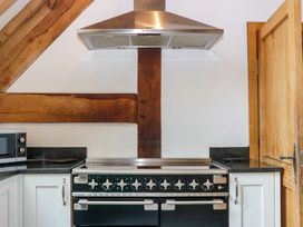 A kitchen with a cooker and microwave at The Roundhouse in Halwell
