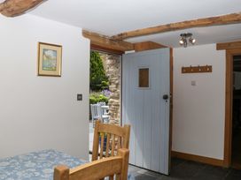 A dining room with a table and chair at The Hay Barn in Halwell