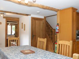 A dining room with a table and chairs at The Hay Barn Halwell