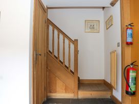A staircase and a door in a hallway at The Hay Barn in Halwell