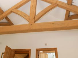 Wooden beams and doors in a room at The Hay Barn Halwell