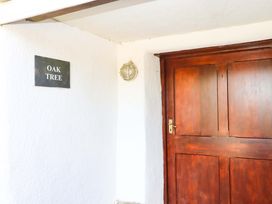 An entrance with a door and a sign at Oak Tree in Halwell