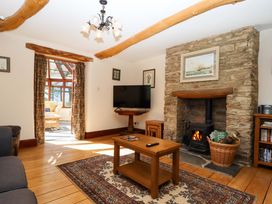A living room with a fireplace and television at Oak Tree Halwell