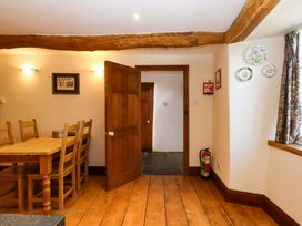 A dining room with a wooden table and chairs at Oak Tree Halwell