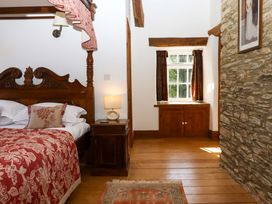 A bedroom with a bed and window at Oak Tree in Halwell
