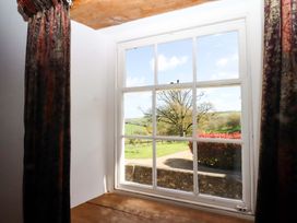A window with curtains and a view of the landscape at Oak Tree Halwell