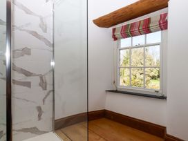 A bathroom with a shower and window at Oak Tree Halwell