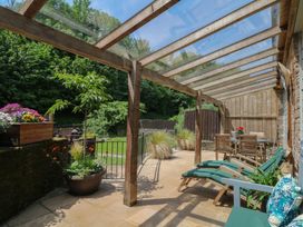 An outdoor patio with a table and chairs at Fixit Cottage in Kingsbridge