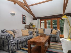 A living room with sofas and a coffee table at Fixit Cottage in Kingsbridge