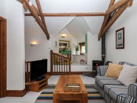 A living room with a sofa and coffee table at Fixit Cottage in Kingsbridge