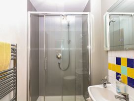 A bathroom with a shower and sink at Fixit Cottage in Kingsbridge