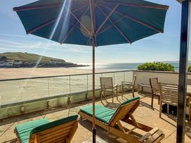 An outdoor terrace with sun loungers and a view of the sea at 5 Burgh Island Causeway Bigbury-on-Sea