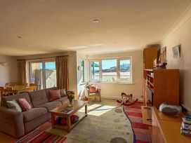 A living room with a sofa, coffee table and dining area at 5 Burgh Island Causeway Bigbury-on-Sea
