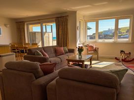 A living room with a sofa and table at 5 Burgh Island Causeway in Bigbury-on-Sea