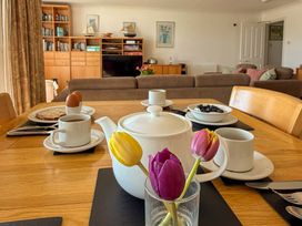 A dining room with a table set for breakfast at 5 Burgh Island Causeway Bigbury-on-Sea