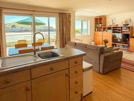 A living room with a kitchen area and a view at 5 Burgh Island Causeway Bigbury-on-Sea