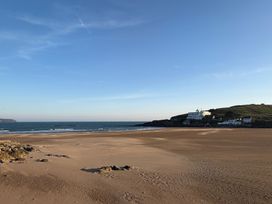 A beach view with sea and buildings at 5 Burgh Island Causeway Bigbury-on-Sea