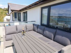 An outdoor seating area with a sofa and table at 27 Burgh Island Causeway in Bigbury-on-Sea