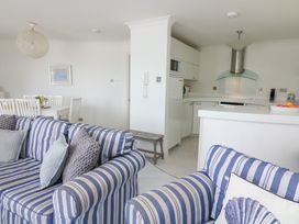 A living room with a kitchen and dining area at 27 Burgh Island Causeway Bigbury-on-Sea