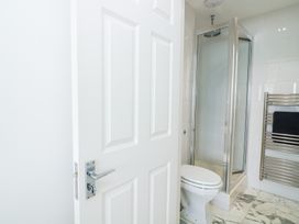 A bathroom with a shower, toilet, and towel rail at 27 Burgh Island Causeway Bigbury-on-Sea