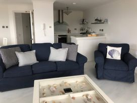 A living room with a sofa and armchair in 27 Burgh Island Causeway Bigbury-on-Sea
